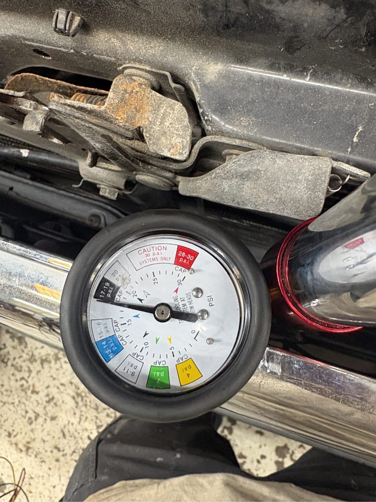 Cooling system pressure tester gauge connected to the Tacoma radiator